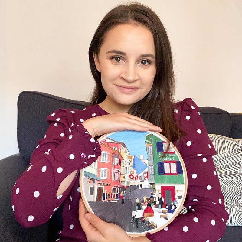 Megan holds a hoop of her work from Nutmeg Embroidery