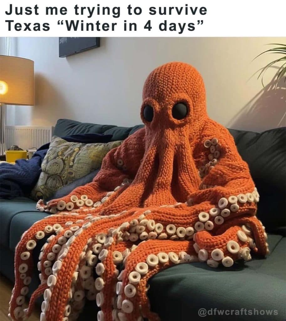 a person sits on a couch in a giant octopus throw/sweater in orange.  You cannot see their face or any part of their body.