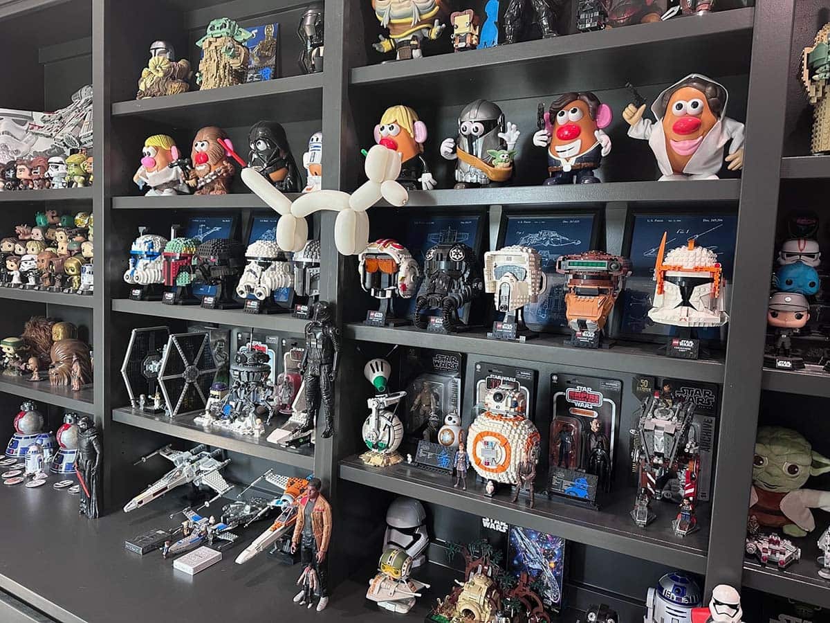 Shelves of collectibles are now joined by the white balloon animal dog that Elena made for Christopher