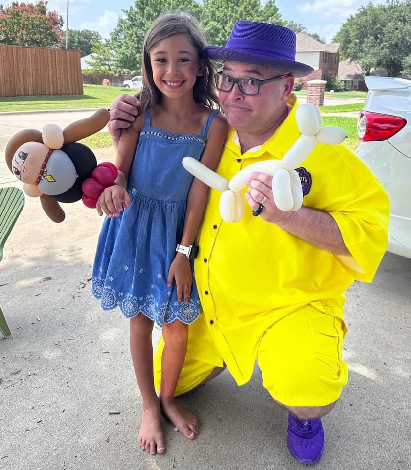 guy in the yellow suit Christopher lyle created a balloon animal for Elena in exchange for his balloon animal dog she made